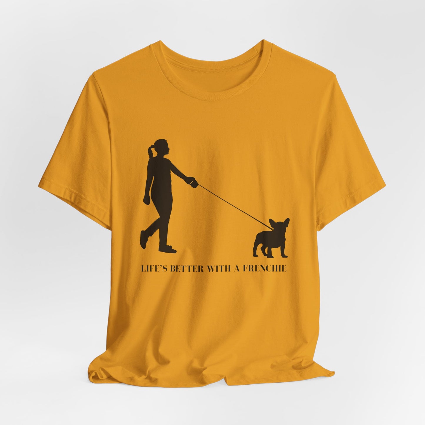 Yellow t-shirt with a black silhouette of a person walking a dog and text on a white background