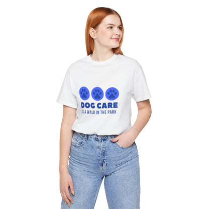 Person wearing a white t-shirt with blue paw prints and text on a white background