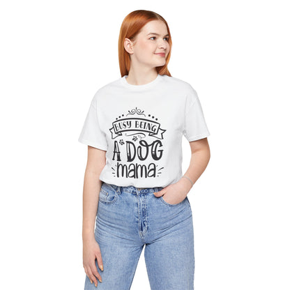 Person wearing a white t-shirt with 'Busy being a dog mama' text on a white background