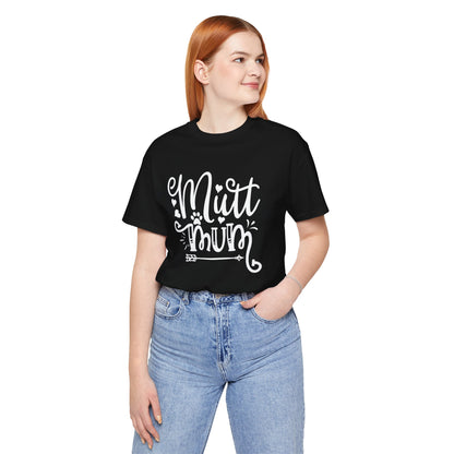 Person wearing a black t-shirt with 'Mutt Mum' text and blue jeans on a white background