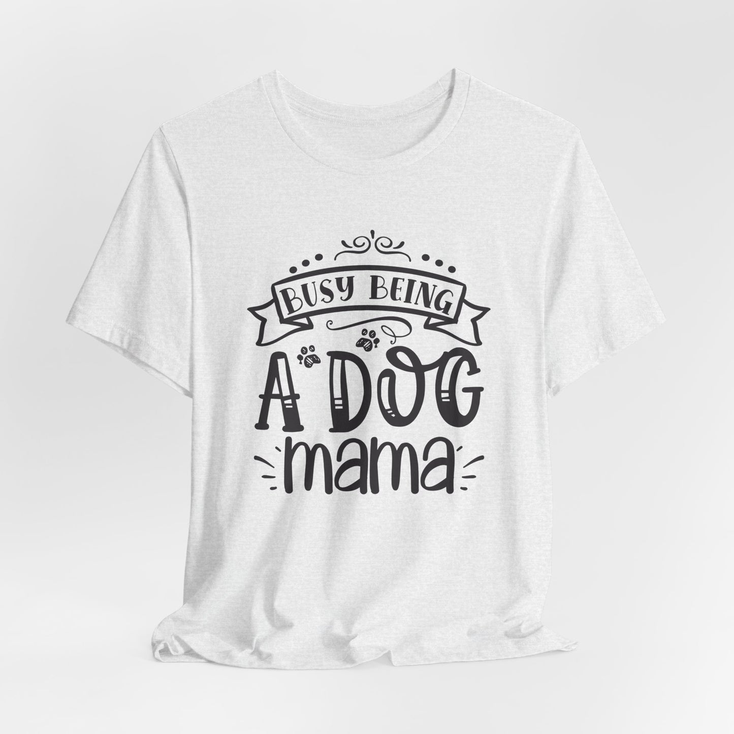 White t-shirt with 'Busy Being A Dog Mama' text on a white background