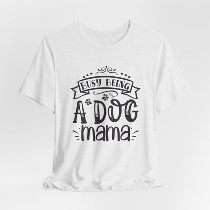 White t-shirt with 'Busy Being A Dog Mama' text on a white background