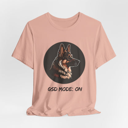 Pink t-shirt with a dog graphic and 'GSD Mode: On' text on a light gray background