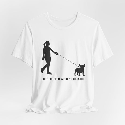 White t-shirt with black silhouette of a person walking a dog and text 'Life's better with a Frenchie' on a white background