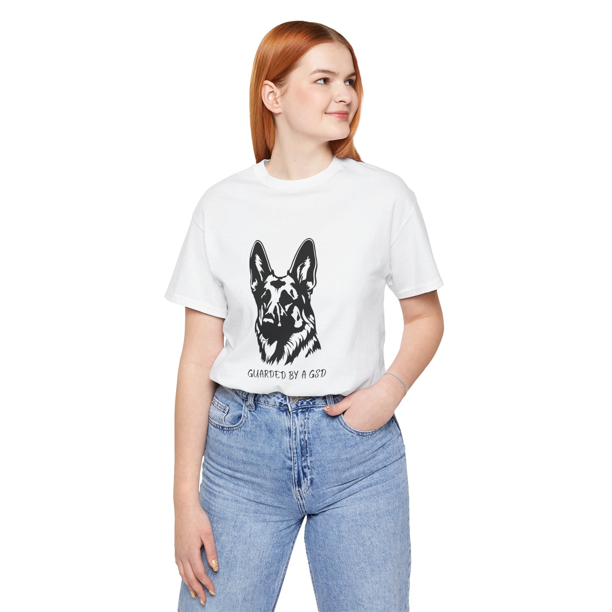 Person wearing a white t-shirt with a graphic of a dog and text, standing against a white background