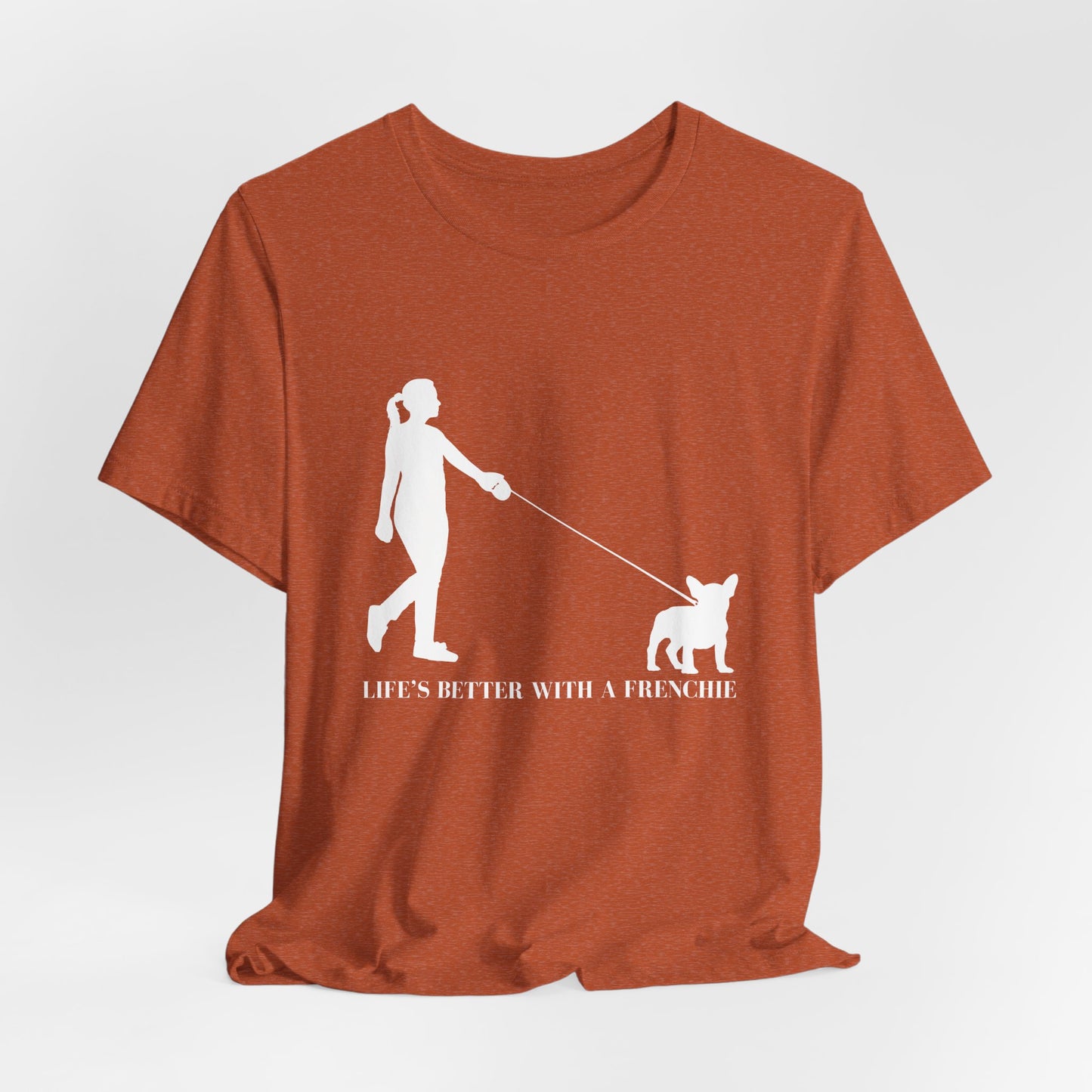 Brown t-shirt with white graphic and text 'Life's better with a Frenchie' on a light gray background
