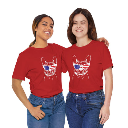 Two people wearing red t-shirts with a dog graphic and sunglasses on a white background