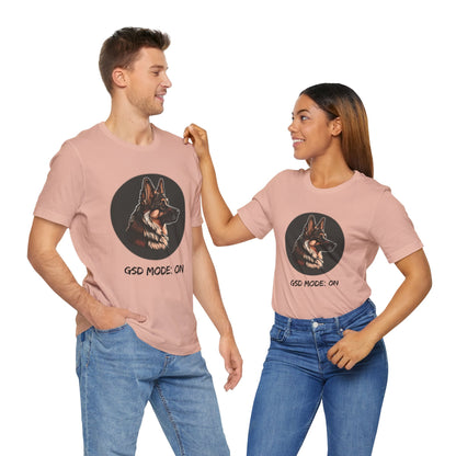 Two people wearing matching pink t-shirts with a dog graphic and 'GSD Mode: On' text.