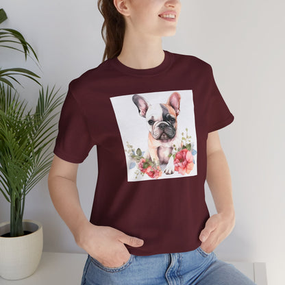 Person wearing a maroon t-shirt with a dog and floral design, standing indoors.