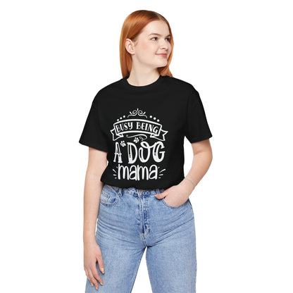 Person wearing a black t-shirt with 'Busy Being A Dog Mama' text on a white background