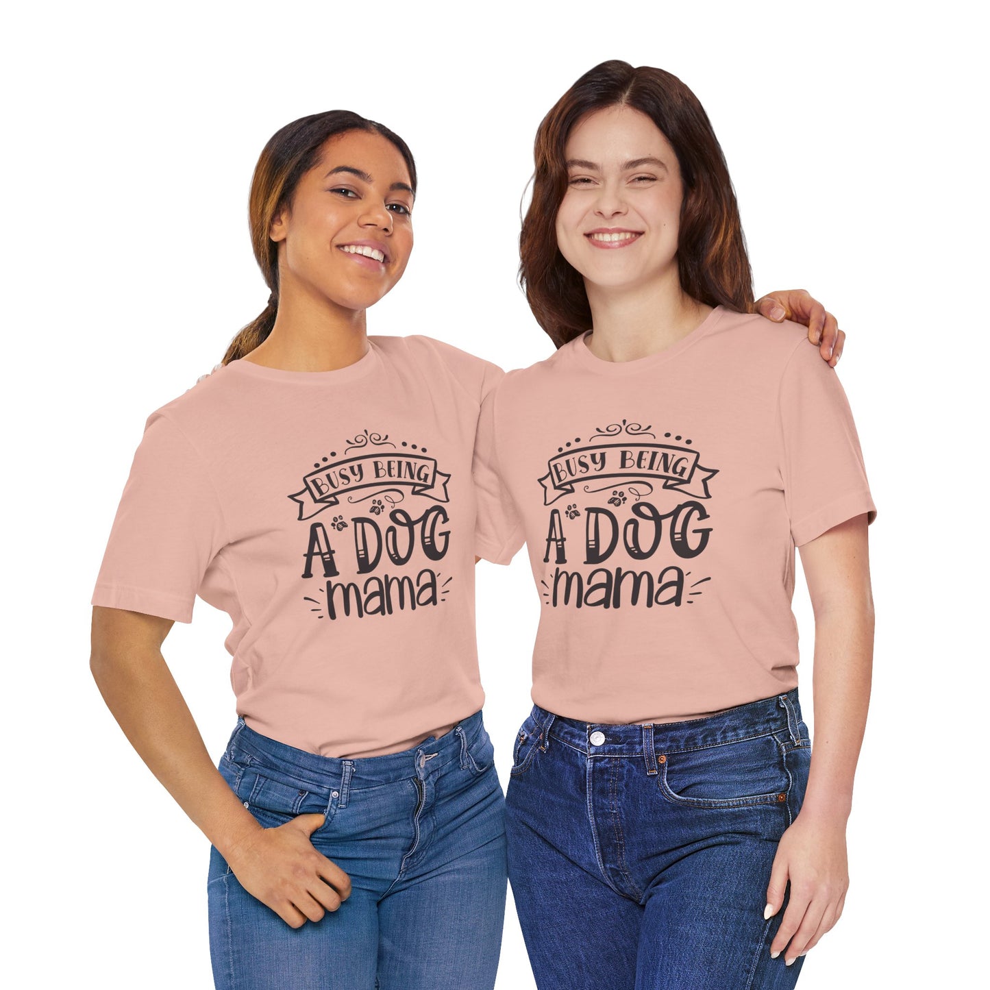 Two women wearing pink t-shirts with 'Busy Being A Dog Mama' text on a white background