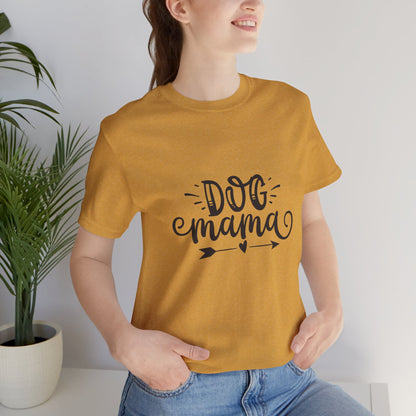 Person wearing a mustard yellow t-shirt with 'DOG mama' text, standing indoors.