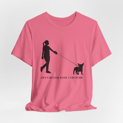 Pink t-shirt with a black silhouette of a person walking a dog and text 'Life's better with a Frenchie' on a white background.